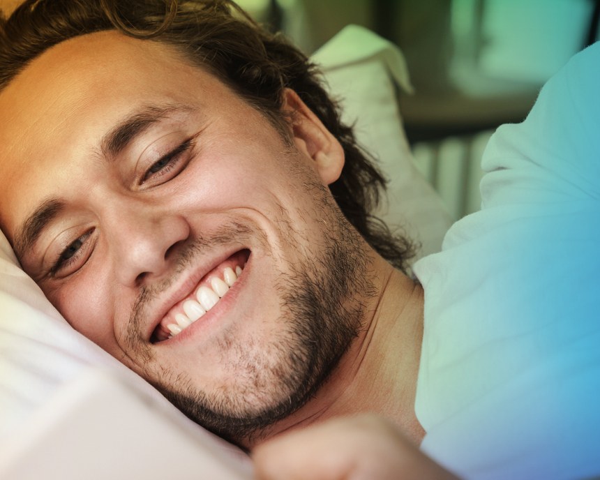 Man smiling while talking on the phone